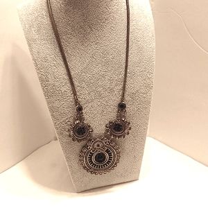Brass colored necklace w/ black stones.